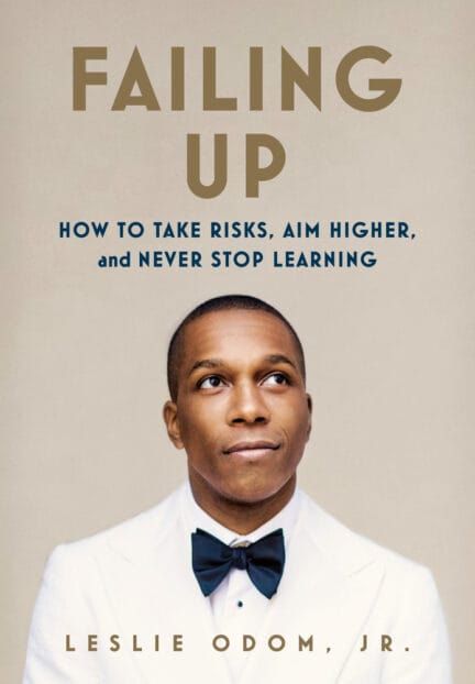 Leslie Odum, Jr. in a white tuxedo and black bow tie glances up, on the cover of his book Falling Up.
