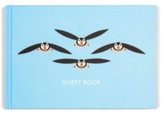 cover for a guest book with flying puffins